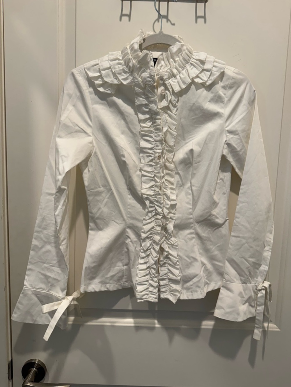iROO ruffled blouse featuring a high collar. Size 38. New.